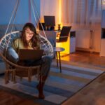 Woman working remotely from home late at night using laptop computer
